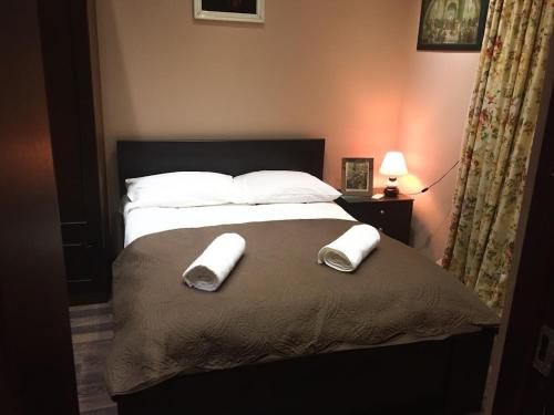 a bedroom with a bed with two towels on it at The Sindh Hostel Tbilisi in Tbilisi City