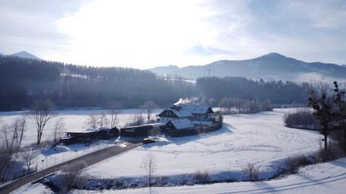 an aerial view of a house in the snow at Tischlmühle Appartements & mehr in Gröbming