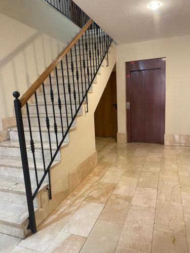 a hallway with stairs and a door in a building at A un Paso de la Catedral in Burgos
