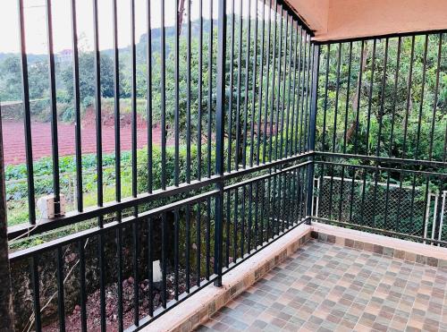 a balcony with a black fence and a view at ShriHari Villa in Panchgani