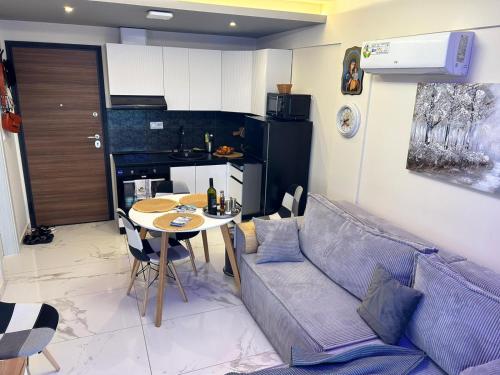 a living room with a couch and a table at New and modern appartament in Greece in Paralia Katerinis