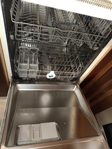 a dish drying rack in a kitchen sink at Sweet Home Lina in Paralia Katerinis