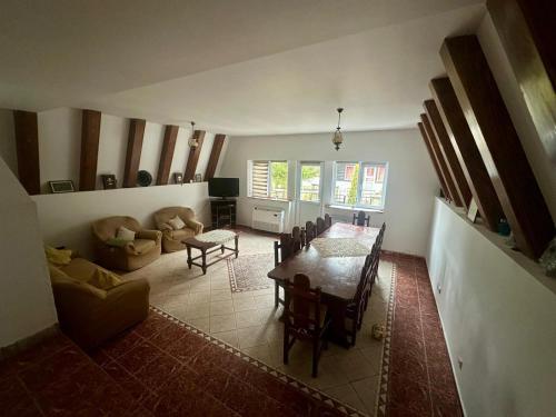 a living room with a table and a couch at Casă de vacanță Cheia in Cheia