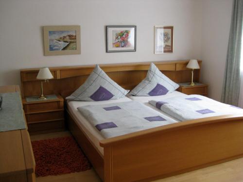 ein Schlafzimmer mit einem großen Bett mit lila Kissen in der Unterkunft Haus Brand in Bad Kissingen