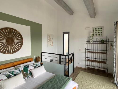 ein Schlafzimmer mit einem Bett und einem Spiegel an der Wand in der Unterkunft Maison avec ses 2 terrasses et sa piscine in Eyragues