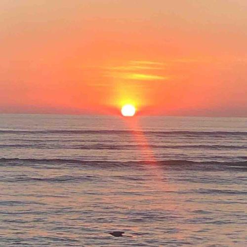 a sunset over the ocean with the sun setting at Casa Monos in Quepos