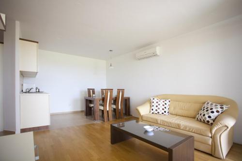 a living room with a couch and a table at Apartma Moravske Toplice in Moravske Toplice