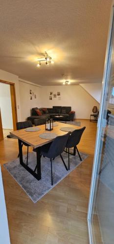 a living room with a table and a couch at Ferienwohnung Alte Wache 12 DG in Holzminden