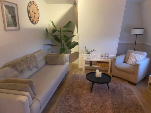 a living room with a couch and a chair and a table at Veldhorst Apartments in Leiden
