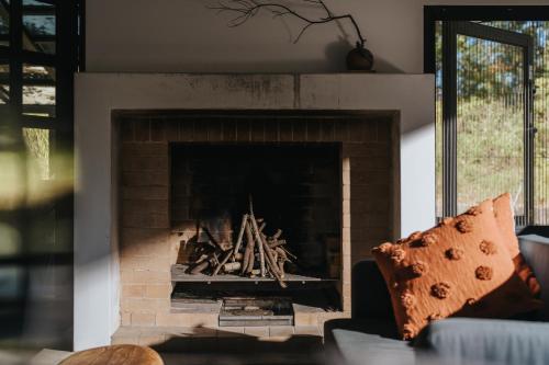 a living room with a brick fireplace at Yanyu Yuchi BY REINDEER in Yuchi