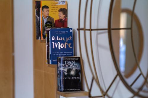 a shelf with some books on a wall at Jemhaus Studio Sunset Seaview [Netflix & Cuckoo] in Lumut