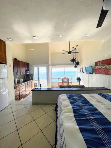 a large kitchen with a pool table in it at Oceanfront-Ocean View in Bucerias Casita Oasis Condo - Large Studio in Bucerías