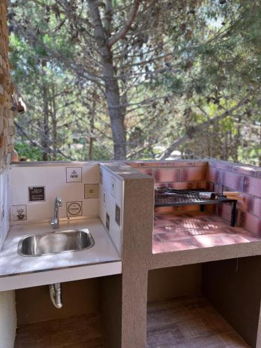a kitchen with a sink and a counter top at Brisas del Jagüel Depto 5 in Santa Teresita