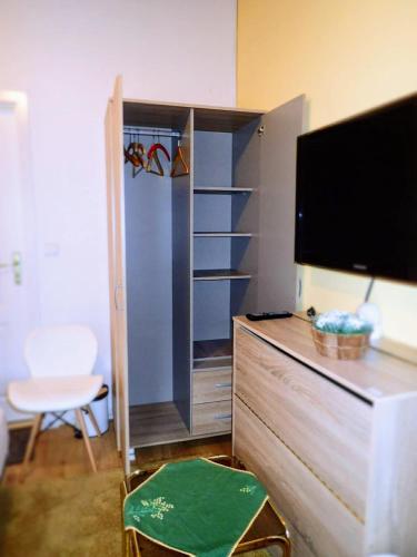 a living room with a tv and a entertainment center at Ubytovanie Clematis in Trenčianske Teplice