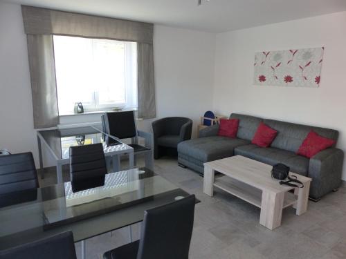 a living room with a couch and a table at Ferienhaus Roebel Mueritz in Marienfelde
