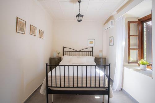 a bedroom with a bed in a white room at Villagio Magnolia in Sívros