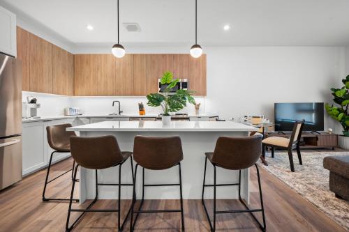 a kitchen with a large white island in a room at Luxury Furnished Apartment Near Logan Airport in Boston