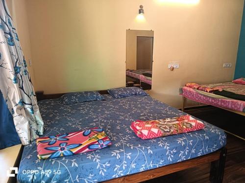 a bedroom with two beds with pillows on it at gokarna beach stay in Gokarn