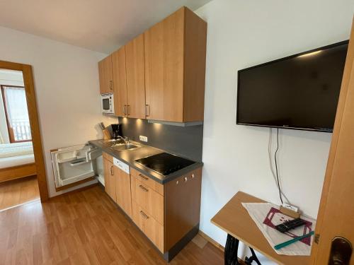 a small kitchen with a sink and a microwave at Brunnerhof in Strassen