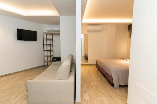 two images of a room with a bed and a tv at Vesuvio Inn Bed & Wine Experience in Boscotrecase