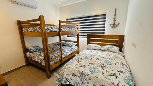 Llit o llits en una habitació de Punta Popy Beach Apartment