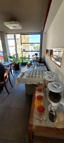 a group of tables in a room with food at Hotel boutique Tramas Andinas in Salta