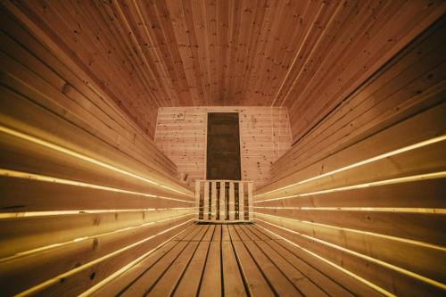 a wooden ceiling with lights in a room at Q Chalet in Săcele