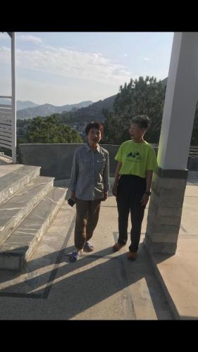 two men walking down the steps of a building at SWAT HiLL ViEW RESORT-only for families in Swat