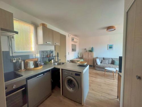 a kitchen with a washing machine in the middle of a room at Appartement Calvi A Moresca in Calvi