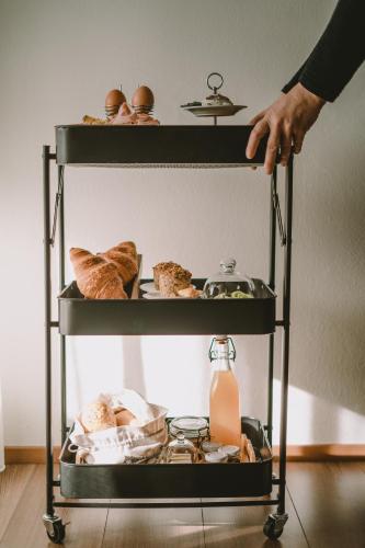 a person reaching for a shelf with food on it at Luisashaus in Tirolo