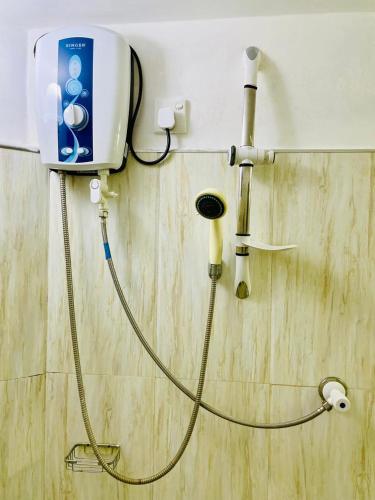 a shower in a bathroom with a blow dryer at Secret Garden Mirissa in Mirissa