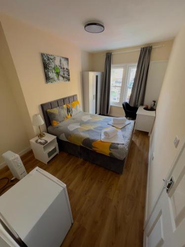 a small bedroom with a bed and a desk at Central quality point piccadilly in London