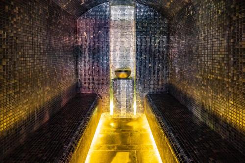 a tunnel with a urinal in a brick wall at Q Chalet in Săcele