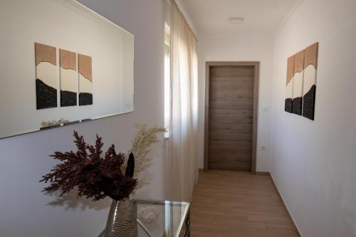 a hallway with white walls and a hallway with a door at Villa Angela in Šmrika