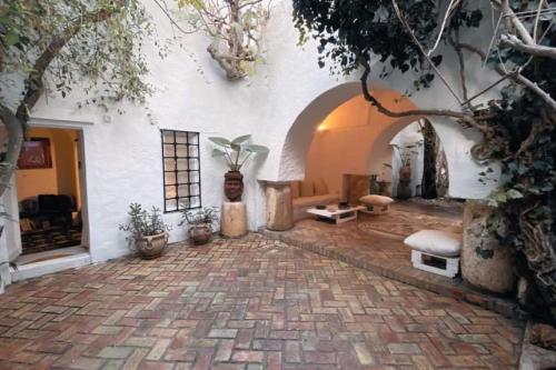 a courtyard with a stone floor and a building at Maison Les Cyprès in Hammamet