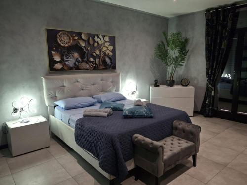 a bedroom with a large bed with a purple blanket at Matilde Valletta Suites in Valletta