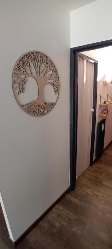 a wall with a picture of a tree on the wall at Appartement vue Lac Thyez in Thyez