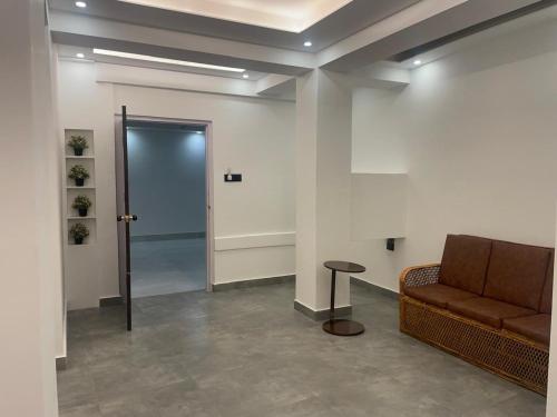 a lobby with a couch and a table and a door at BLUE ANGEL Guest House in Shillong