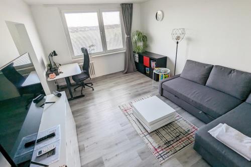 a living room with a couch and a table at Smart Apartment in Znojmo