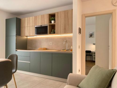 a kitchen with blue cabinets and a counter top at Casa di Maggie 1 - Comfort e natura tra Pinzolo e Campiglio in Carisolo