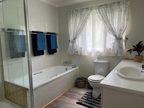 a bathroom with a tub and a toilet and a sink at Vaal River Views in Lindequesdrif
