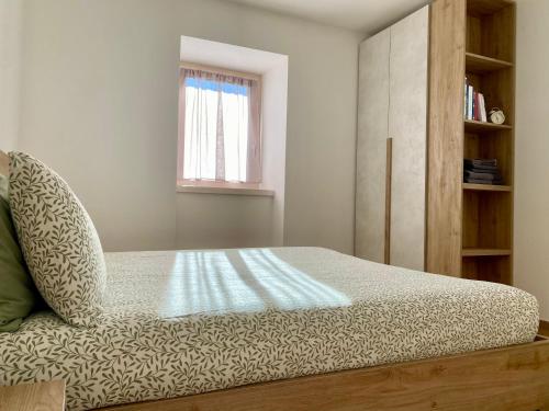 a bedroom with a bed and a book shelf at Casa di Maggie 1 - Comfort e natura tra Pinzolo e Campiglio in Carisolo