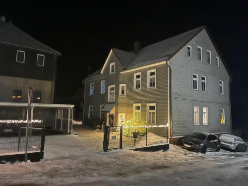 a large house with christmas lights in front of it at Zur-kleinen-Auszeit in Benneckenstein