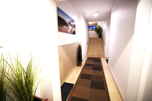 a hallway with a checkered floor in a house at Willa Asia in Sromowce Niżne
