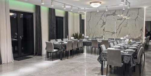 a dining room with a long table and chairs at Sunrise Wola Mokrzeska Sala Bankietowa i Apartamenty in Wola Mokrzeska