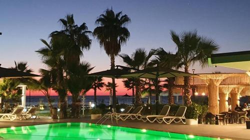 a swimming pool with chairs and umbrellas at a resort at Comfort Suites in Golem