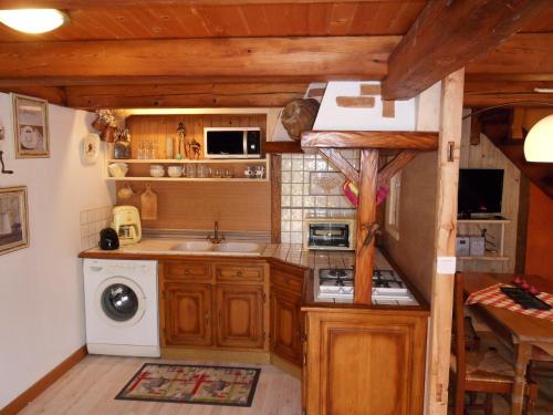 a small kitchen with a sink and a stove at Les Hirondelles in Lapoutroie