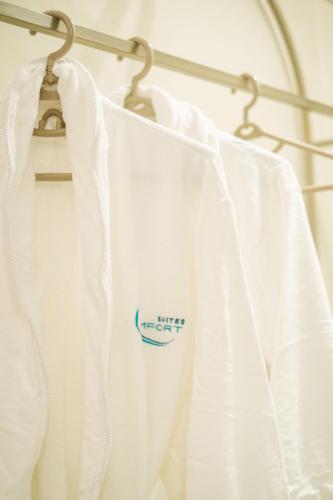a towel rack with white curtains on it at Comfort Suites in Golem