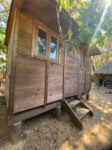 a small wooden cabin with two windows in a tree at Casa Teepee in Zipolite