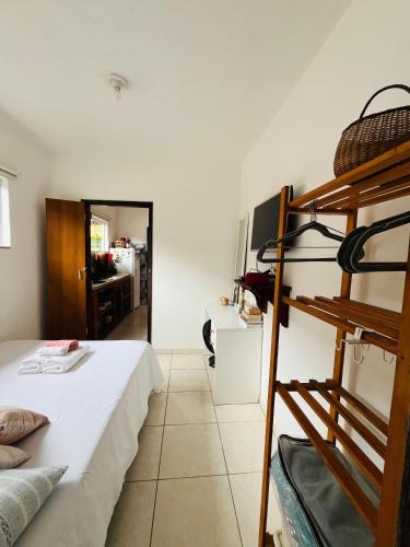 a bedroom with a bed and a bunk bed at Microcasa Aconchego Paraty in Paraty